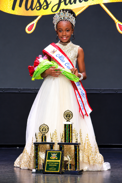Teylyn Prater-Fulliere, Little Miss Juneteenth USA 2026, with her crown, flowers, and trophies